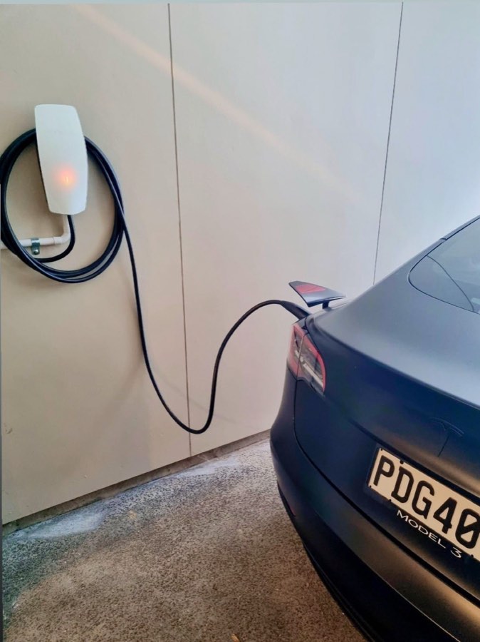 An EV charger installed on a garage wall